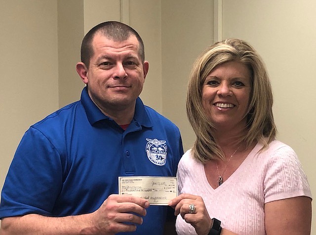 Amy Maxwell, left, chairwoman of the EMS Week Bass Tournament, presented $2,500 to Stacy Prater, scholarship fund treasurer of the Southeastern EMS Director's Association.
