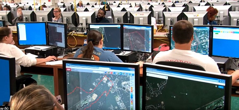 In this undated image provided by the U.S. Census Bureau, shows census geographers at census headquarters in Suitland, Md., using the Block Assessment, Research and Classification Application (BARC) to help get an accurate population count next year. Census employees are taking images captured from satellites and planes to verify addresses in rural communities and compare them to previous maps from 2010. (U.S. Census Bureau via AP)