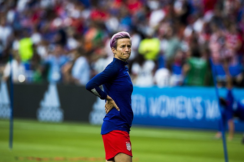 U.S. forward Megan Rapinoe watches teammates warm up before the Women's World Cup semifinal match between the U.S. and England at Stade de Lyon in Lyon, France, last Tuesday. The U.S. won 2-1. (Pete Kiehart/The New York Times)