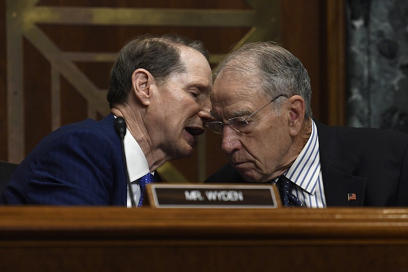 Senate Finance Committee ranking member Sen. Ron Wyden, D-Ore., left, talks with committee chairman Sen. Chuck Grassley, R-Iowa, right, during a hearing with United States Trade Representative Robert Lighthizer on Capitol Hill in Washington, Tuesday, June 18, 2019, on 'The President's 2019 Trade Policy Agenda and the United States-Mexico-Canada Agreement'. (AP Photo/Susan Walsh)