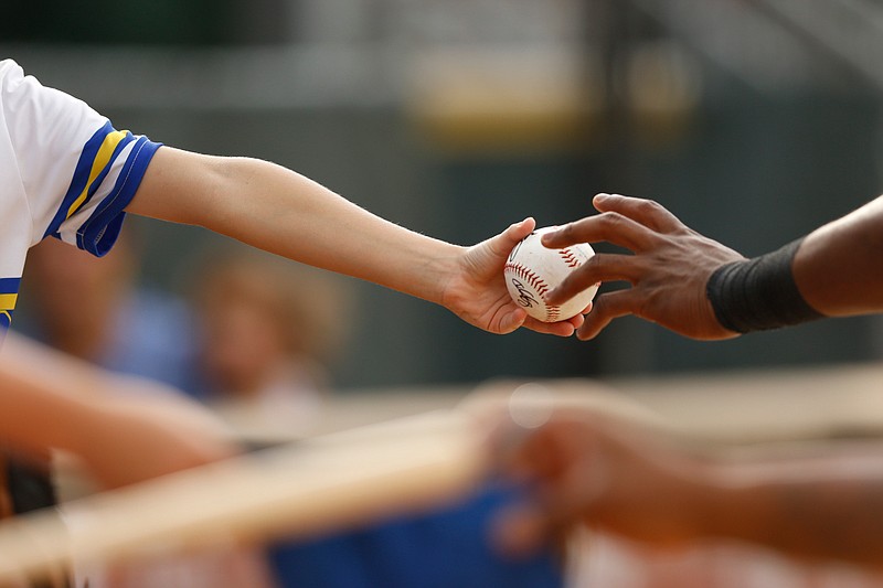 A fan gets a ball signed by a Chattanooga player during the Lookouts' home baseball game against the Jackson Generals at AT&T Field on Friday, July 5, 2019, in Chattanooga, Tenn. 