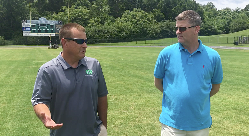 Stephen Hargis talks with new East Hamilton High School football coach Grant Reynolds.