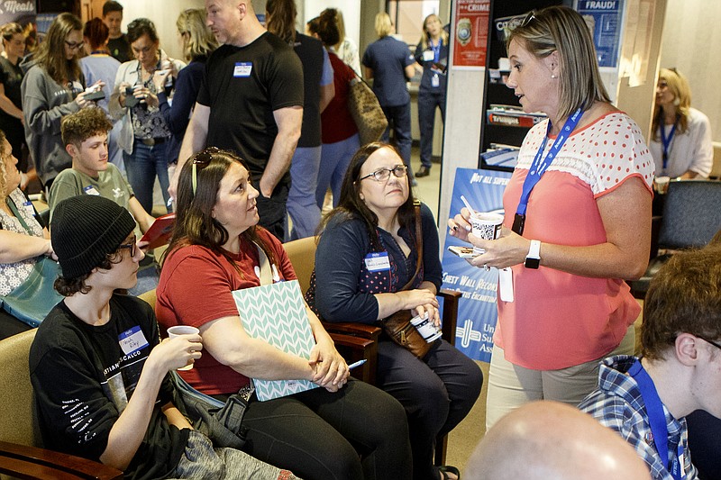 Noah Riley, left, and his mother Stacey Kight, second from left, listen as Staci Smith talks to them during the Pectacular! ice cream social in the University Surgical Associates office in Erlanger Health System's Medical Mall on Tuesday, April 23, 2019 in Chattanooga, Tenn. Smith's daughter had the surgery.