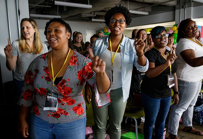 Educators sing along with a video played by keynote speaker Dwayne Reed during Teach Like A Boss at The Edney Building on Tuesday, July 9, 2019, in Chattanooga, Tenn. Reed, whose YouTube video "Welcome to the 4th Grade" became a viral sensation, spoke about the importance of student engagement.