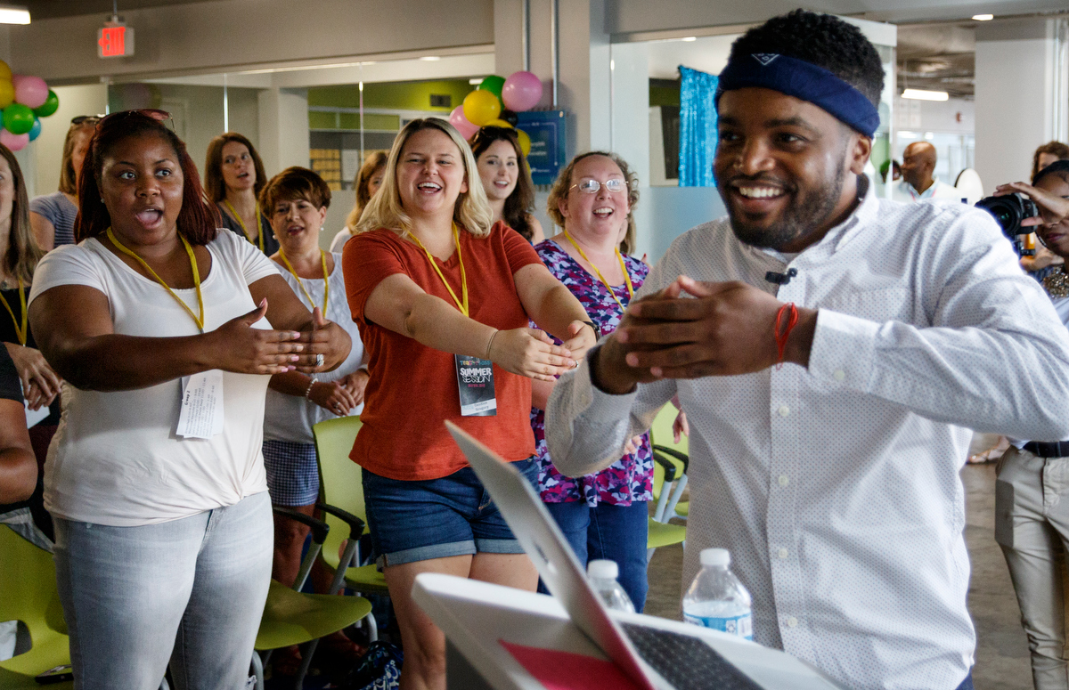 Educators sing along with a video played by keynote speaker Dwayne Reed, right, during Teach Like A Boss at The Edney Building on Tuesday, July 9, 2019, in Chattanooga, Tenn. Reed, whose YouTube video "Welcome to the 4th Grade" became a viral sensation, spoke about the importance of student engagement.