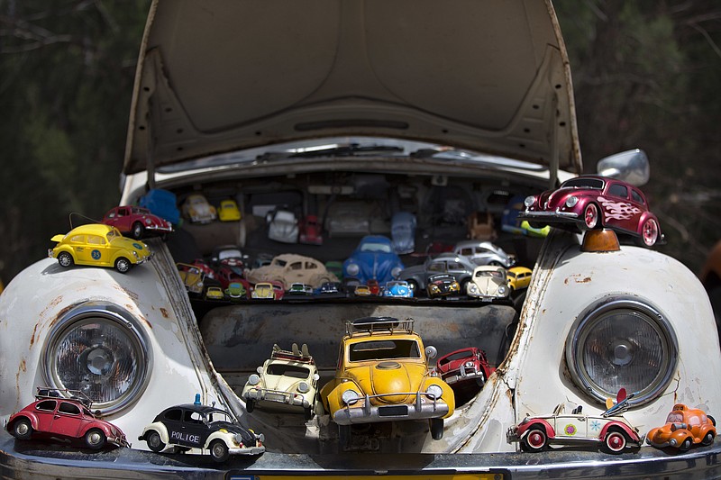 FILE - In this April 21, 2017, file photo a collection of VW beetles car toys seen on Volkswagen Beetle displayed during the annual gathering of the "Beetle Club" in Yakum, central Israel. Volkswagen is halting production of the last version of its Beetle model in July 2019 at its plant in Puebla, Mexico, the end of the road for a vehicle that has symbolized many things over a history spanning eight decades since 1938. (AP Photo/Oded Balilty)