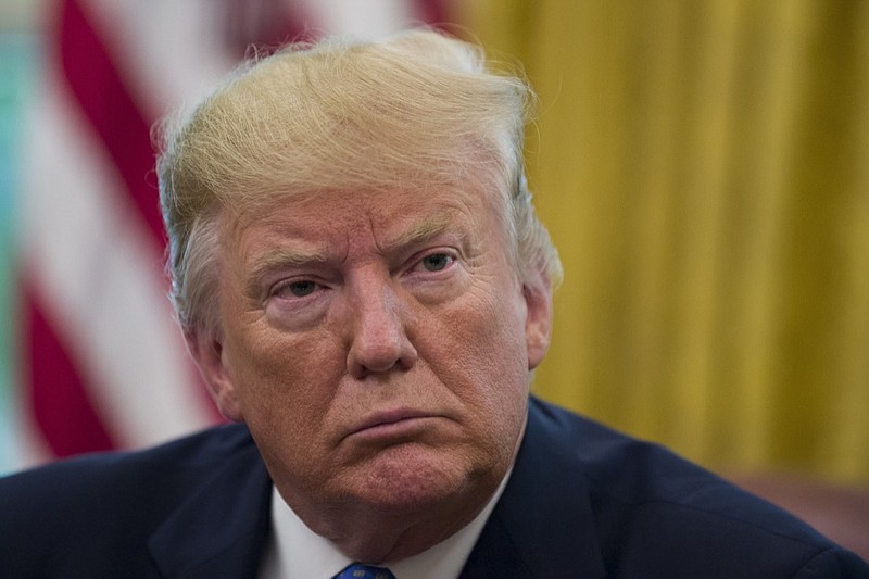 In this June 25, 2019, file photo, President Donald Trump listens in the Oval Office of the White House in Washington. Over 20 state governors are backing California leaders in a showdown with the Trump administration over mileage standards. (AP Photo/Alex Brandon, File)
