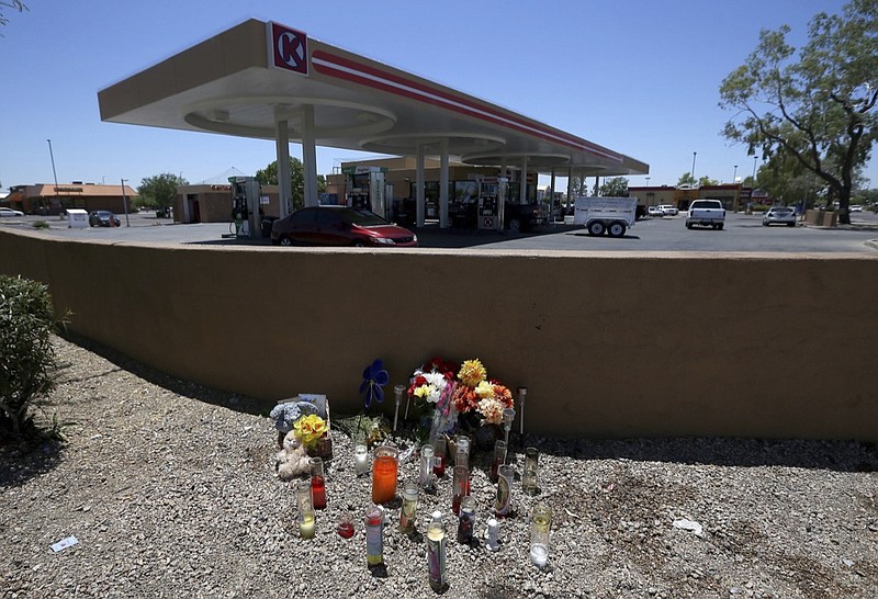 A makeshift memorial is set up for Elijah Al-Amin at a local Circle K store for the death of the stabbing victim Tuesday, July 9, 2019, in Peoria, Ariz. Peoria police arrested 27-year-old Michael Adams on suspicion of first-degree murder in the killing of 17-year-old Al-Amin, who was stabbed in his throat and back inside the store on July 4. Hundreds of people including a presidential candidate are speaking out on Twitter about the killing of a 17-year-old Muslim youth at a suburban convenience store by a white man who said he was threatened by the boy's rap music. (AP Photo/Ross D. Franklin)