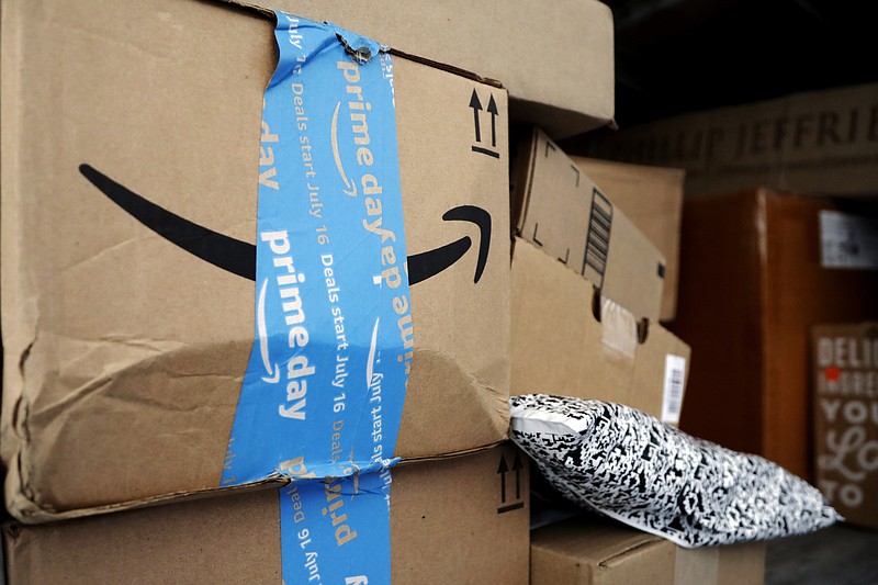 FILE - In this July 17, 2018, file photo Amazon Prime packages sit in an UPS delivery truck before being unloaded in Miami. Amazon’s “Prime Day” is back. The made-up holiday, first launched in 2015, has become one of Amazon’s busiest shopping days, offering discounts on gadgets, TVs and other goods. (AP Photo/Lynne Sladky, File)