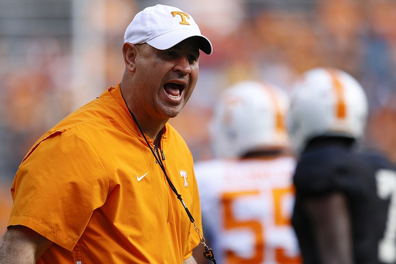 Tennessee football coach Jeremy Pruitt shouts as players warm up for the Orange and White spring game April 13 in Knoxville. The program committed three Level III NCAA violations, which are considered minor, in the first six months of 2019.