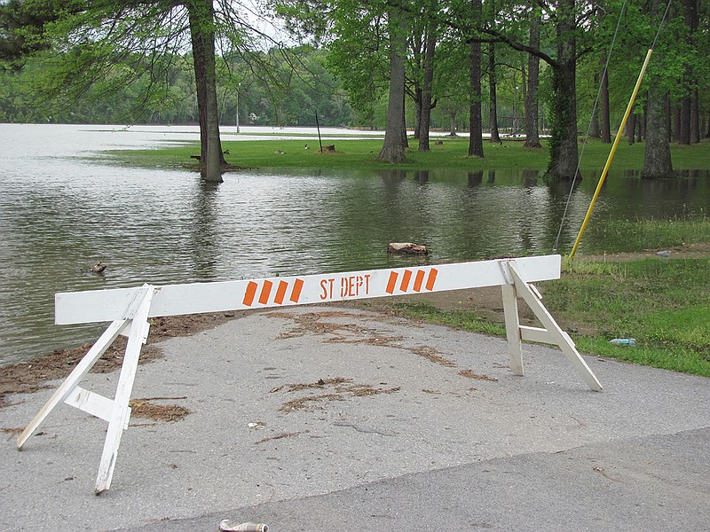 In this 2011 staff file photo, a road that leads to riverfront picnic tables at Point Park in Dayton, Tennessee, was closed after heavy rainfall flooded the area.