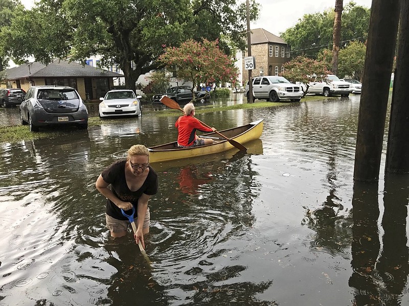 People cope with the aftermath of severe weather in the Broadmoor neighborhood in New Orleans, Wednesday, July 10, 2019.  (Nick Reimann/The Advocate via AP)