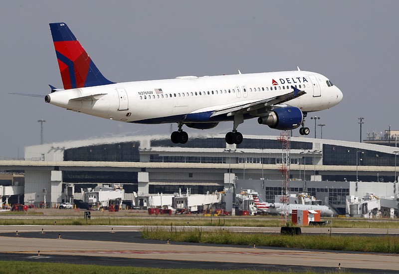 FILE - In this June 24, 2019, file photo a Delta Air Lines aircraft makes its approach at Dallas-Fort Worth International Airport in Grapevine, Texas. Delta Air Lines, Inc. reports earnings Wednesday, July 10. (AP Photo/Tony Gutierrez, File)