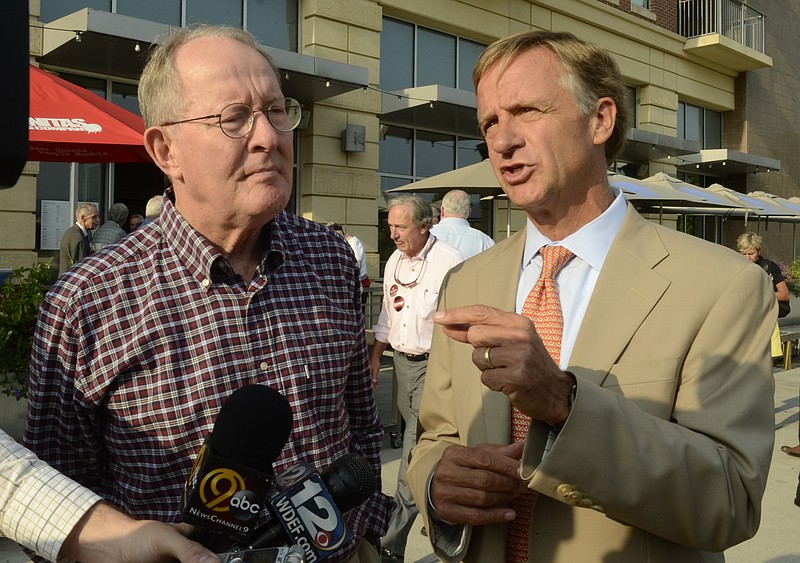 Tennessee Gov. Bill Haslam, right, and Sen. Lamar Alexander speak in 2014 with reporters in Chattanooga. Haslam says he has decided not to seek Alexander's U.S. Senate seat. / Staff file photo by John Rawlston