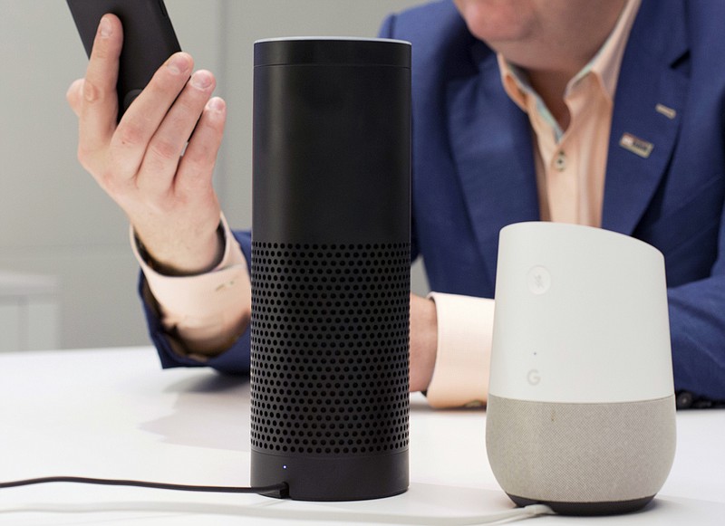 FILE - In this June 14, 2018, photo, an Amazon Echo, center, and a Google Home, right, are displayed in New York. Google contractors are listening to some recordings of people talking to Assistant, either on their phone or through smart speakers such as the Google Home. The company says some of its Dutch language recordings were leaked and that it is investigating. (AP Photo/Mark Lennihan, File)