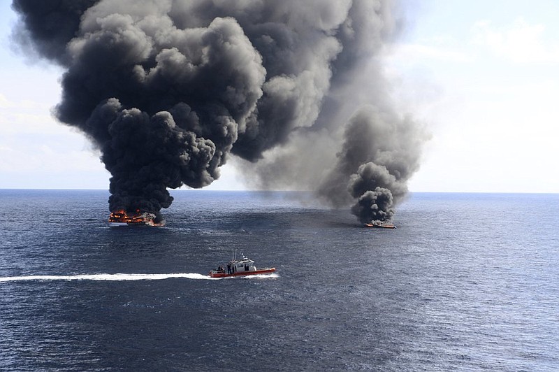 This May 17, 2019 photo provide by the U.S. Coast Guard shows U.S. Coast Guard Cutter Munro (WMSL 755) crew members aboard the cutter's 35-foot Long Range Interceptor small boat supervising the intentional sinking of suspected drug-smuggling boats, following the seizure of cocaine from the boats during an at-sea interdiction while Munro's crew patrolled international waters of the Eastern Pacific Ocean. Due to the distance from land, inadequate tow points and flooding in the engine rooms of the boats, the boats were sunk as a hazard to navigation. (Petty Officer 1st Class Matthew Masaschi/U.S. Coast Guard via AP)