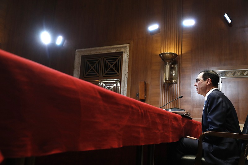FILE- In this May 15, 2019, file photo Treasury Secretary Steve Mnuchin testifies about the budget during a Financial Services and General Government subcommittee hearing on Capitol Hill in Washington. In a letter Friday, July 12, to House and Senate leaders, Mnuchin told congressional leaders that Congress should raise the debt ceiling before leaving for its August recess. He says he could run out of maneuvering room to avoid an unprecedented default on the national debt before lawmakers return. (AP Photo/Jacquelyn Martin, File)