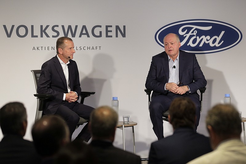 Ford CEO Jim Hackett, right, and Volkswagen CEO Herbert Diess participate in a news conference in New York, Friday, July 12, 2019.   Volkswagen will sink $2.6 billion into a Pittsburgh autonomous vehicle company that's mostly owned by Ford as part of a broader partnership on electric and self-driving vehicles, the companies confirmed Friday.  (AP Photo/Seth Wenig)