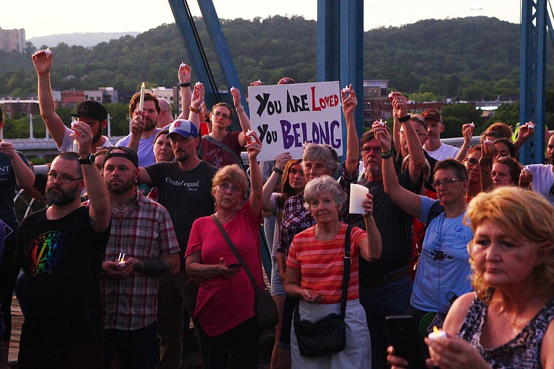 Protests stand on the Walnut Street Bridge to protest the treatment of immigrants at the U.S.-Mexico border. / Staff photo by Wyatt Massey