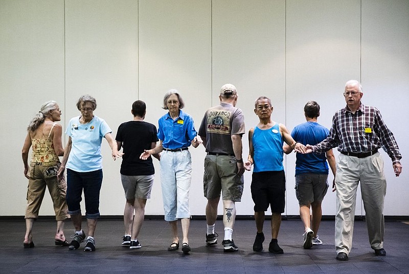 This July 3, 2019 photo shows people participating during the annual International Association of Gay Square Dance Clubs convention in Philadelphia. The annual convention brought in 850 dancers bringing their best promenades and do-si-dos to a slightly sped-up version of "Somewhere Over the Rainbow." (AP Photo/Matt Rourke)