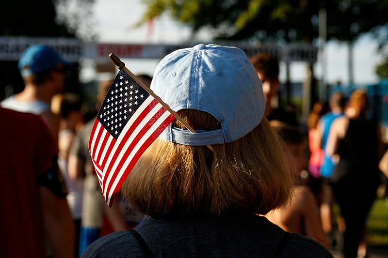 Teresa White wears a flag in her hat before the fourth and final Chattanooga Heroes Run from the Naval Operational Support Center and Marine Corps Reserve Center on Amnicola Highway on Saturday, July 13, 2019, in Chattanooga, Tenn. The run honors the five servicemen killed in the July 16, 2015 shooting at the facility: U.S. Navy Petty Officer Randall Smith, U.S. Marine Corps Sgt. Carson Holmquist, Gunnery Sgt. Thomas Sullivan, Cpl. Squire "Skip" Wells and Staff Sgt. David Wyatt. The run was founded to help fund a permanent memorial for the victims. It is ending this year, because the memorial is almost fully funded.