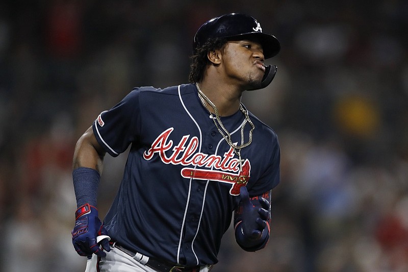 The Atlanta Braves' Ronald Acuna Jr. reacts after hitting a home run during the fifth inning of Friday night's game against the host San Diego Padres.