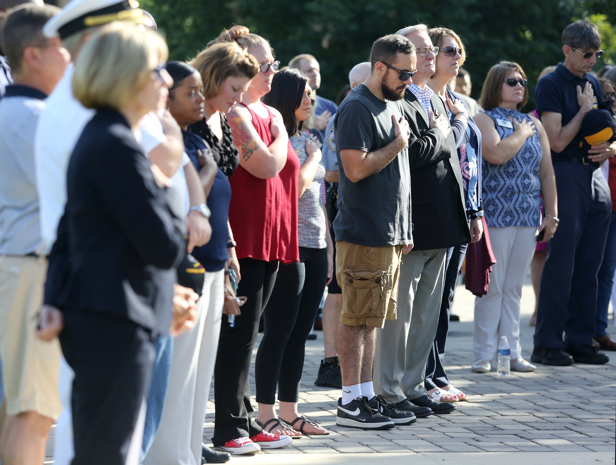 University of Tennessee at Chattanooga staff, students and community members bow their heads as the names of five servicemen who lost their lives in an attack on two military facilities on July 16, 2015 in Chattanooga, Tennessee, are read aloud during a ceremony to remember the Fallen Five at Chamberlain Field Pavilion at UTC in Chattanooga, Tennessee. Sgt. Carson A. Holmquist; Gunnery Sgt. Thomas J. Sullivan; Staff Sgt. David A. Wyatt and Lance Cpl. Squire K. "Skip" Wells, all Marines, and Navy Petty Officer 2nd Class Randall J. Smith were the five servicemen killed in the attack four years ago.