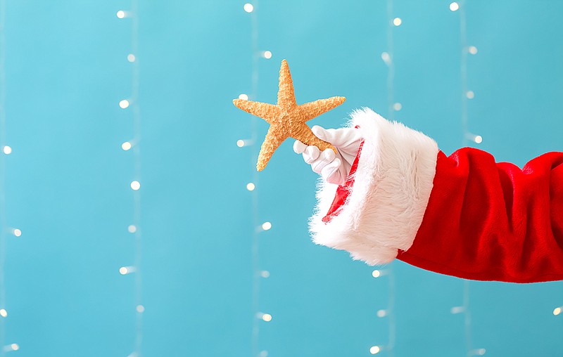 Santa holding a starfish. / Getty Images