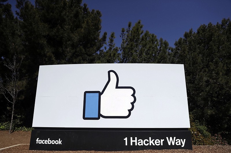 This March 28, 2018, file photo shows a Facebook logo at the company's headquarters in Menlo Park, Calif. Facebook s ambitious plan to create a new financial system based on a digital currency faces questions from lawmakers, as it s shadowed by negative comments from President Donald Trump, his Treasury secretary and the head of the Federal Reserve. (AP Photo/Marcio Jose Sanchez, File)