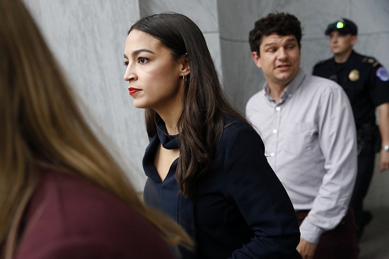 Rep. Alexandria Ocasio-Cortez, D-N.Y., walks out of a House of Representatives office building, Tuesday, July 16, 2019, on Capitol Hill in Washington. (AP Photo/Patrick Semansky)