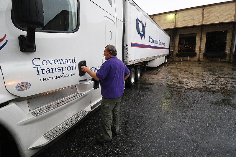 In this 2015 staff file photo, Gary Helms, a master trainer for Covenant Transport, prepares to take a load of soda ash from Chattanooga to Atlanta.