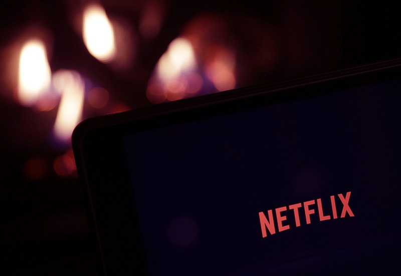 FILE - This Jan. 17, 2017, photo, shows Netflix on a tablet, in North Andover, Mass. On Thursday, July 18, 2019, Netflix said subscribers dropped unexpectedly in the U.S. during the second quarter, raising the question of how much are people willing to pay for streaming services with a host of new ones, from Disney to NBCUniversal, on the way. (AP Photo/Elise Amendola, File)