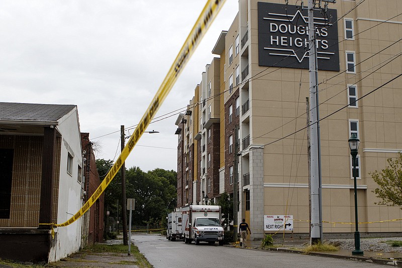 Crime scene tape is draped around University Street on Sunday, July 14, 2019 in Chattanooga, Tenn. Three people were injured in a shooting inside a Douglas Heights apartment Sunday morning just before 4 a.m. One person is said to be in critical condition.