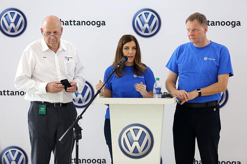 Amanda Plecas, head of communications at Volkswagen Chattanooga, gives reporters the opportunity to ask questions of new Volkswagen Chattanooga CEO Tom du Plessis, at left, and outgoing Volkswagen Chattanooga CEO Frank Fischer, at right, during a press conference at Volkswagen Academy Thursday, July 18, 2019 in Chattanooga, Tennessee.