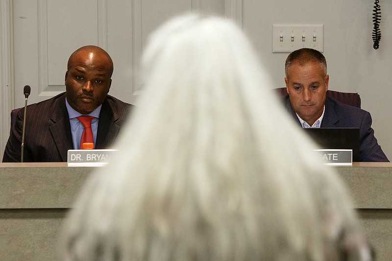 Staff photo by C.B. Schmelter / Superintendent Bryan Johnson, left, and Hamilton County District 7 school board member and chairman Joe Wingate right, listen as Hamilton County Education Association President Jeanette Omarkhail addresses the school board during a meeting in the Hamilton County Schools board room on Thursday, July 18, 2019 in Chattanooga, Tenn.