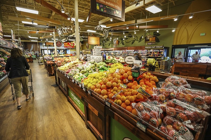 photo: FILE - In this May 25, 2017, file photo, shoppers make their way around the new produce section in the newly-expanded City Market in Eagle, Colo. The supermarket is one of the most important places to be shopping-savvy. The good news is that there are so many easy and effective way to slash your grocery budget. Buy whole fruits and vegetables. Pound for pound, whenever you buy anything that has been peeled, cut up, or prepped in any way you are paying a premium. (Chris Dillmann/Vail Daily via AP, File)
