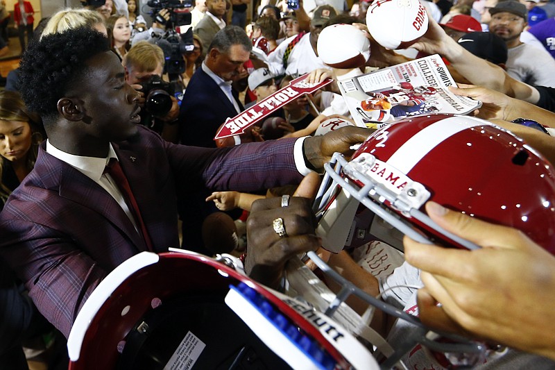 AP photo by Butch Dill / Alabama linebacker Dylan Moses signs autographs at the SEC's annual media days event for its football teams on July 17, 2019, in Hoover, Ala.