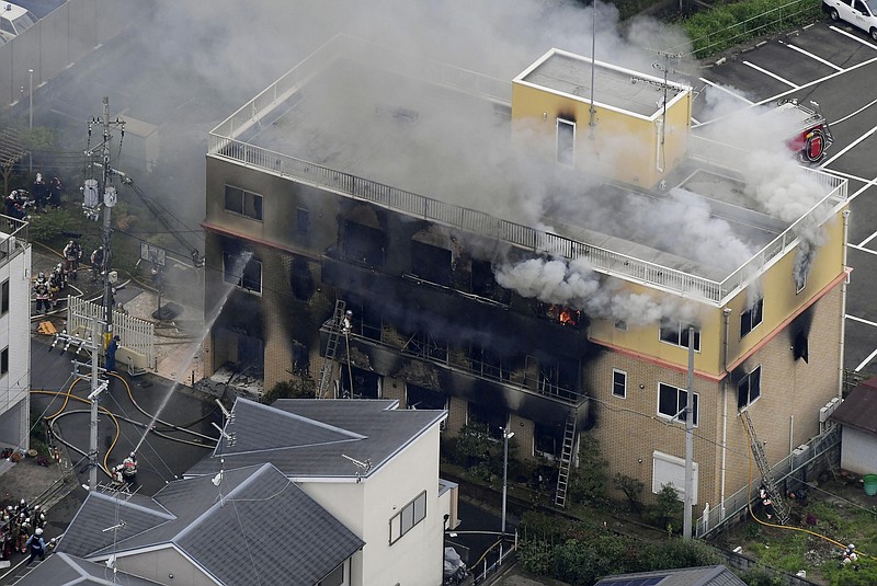 Firefighters respond to a building fire of Kyoto Animation in Kyoto, western Japan, Thursday, July 18, 2019. The fire broke out in the three-story building in Japan's ancient capital of Kyoto, after a suspect sprayed an unidentified liquid to accelerate the blaze, Kyoto prefectural police and fire department officials said.(Kyodo News via AP)

