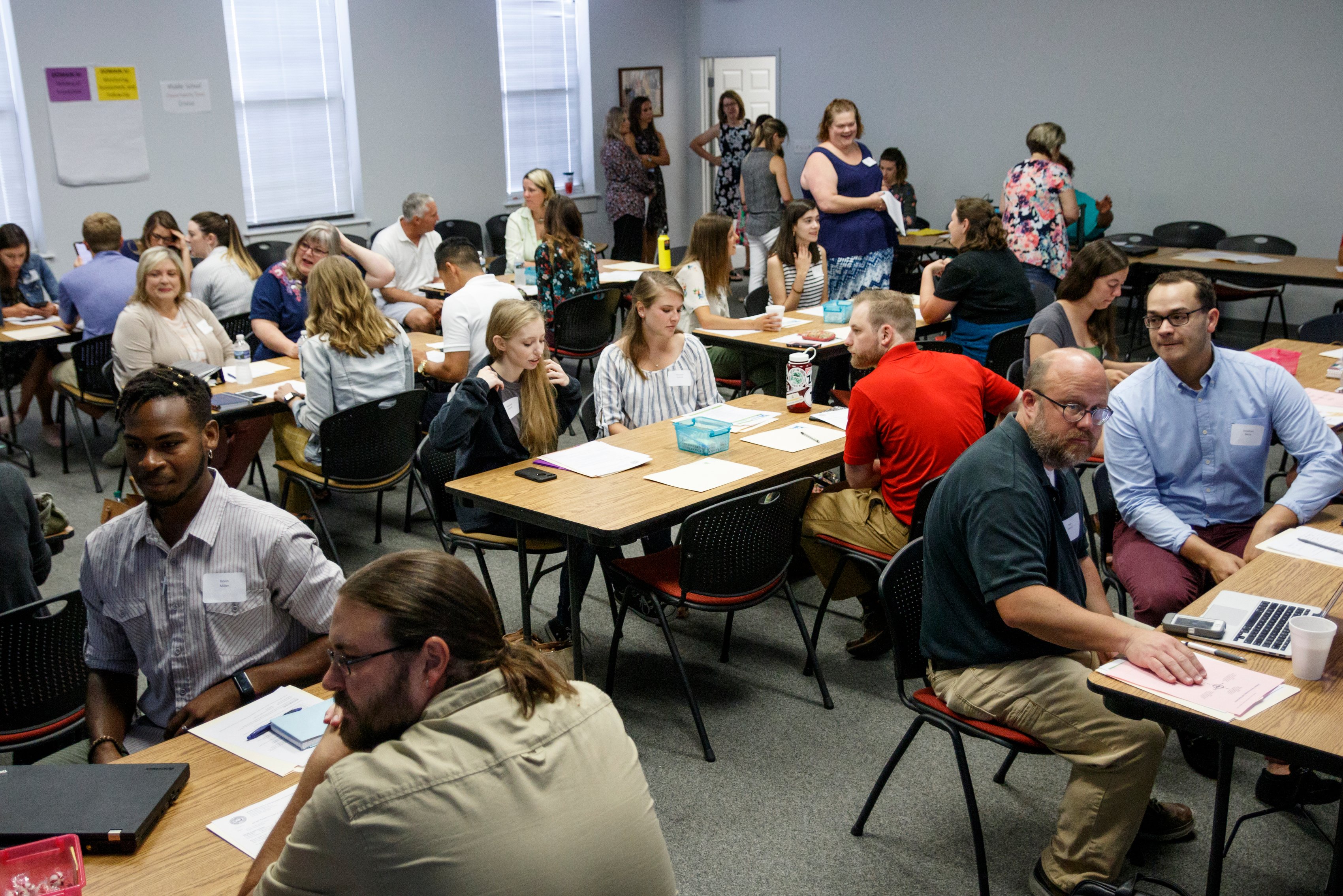 Educators wait for a new hire orientation to begin at Hamilton County Schools Central Office on Wednesday, July 10, 2019, in Chattanooga, Tenn. Teachers and central office hires learned about working for the department during the orientation.