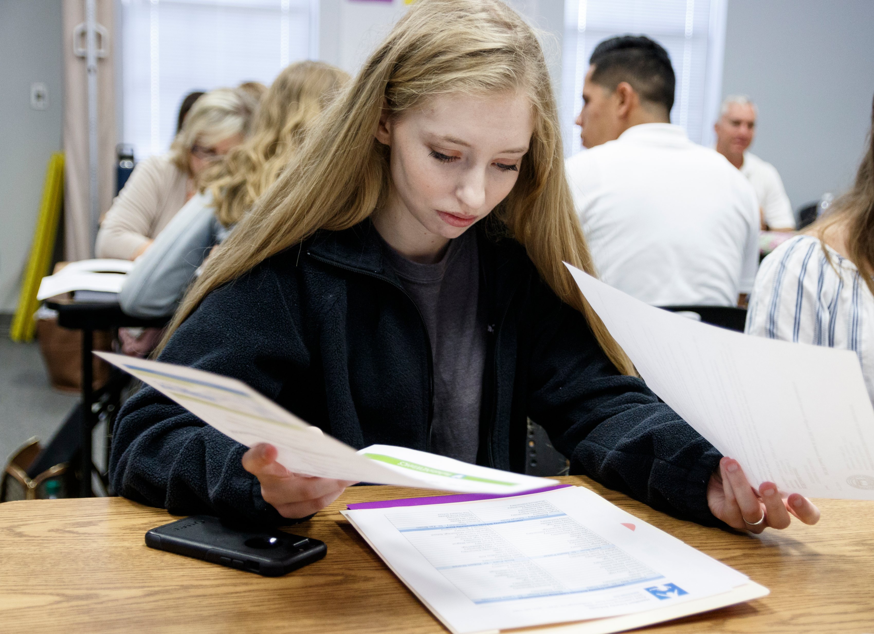 Stephanie Edwards reads materials during a new hire orientation at Hamilton County Schools Central Office on Wednesday, July 10, 2019, in Chattanooga, Tenn. Teachers and central office hires learned about working for the department during the orientation.