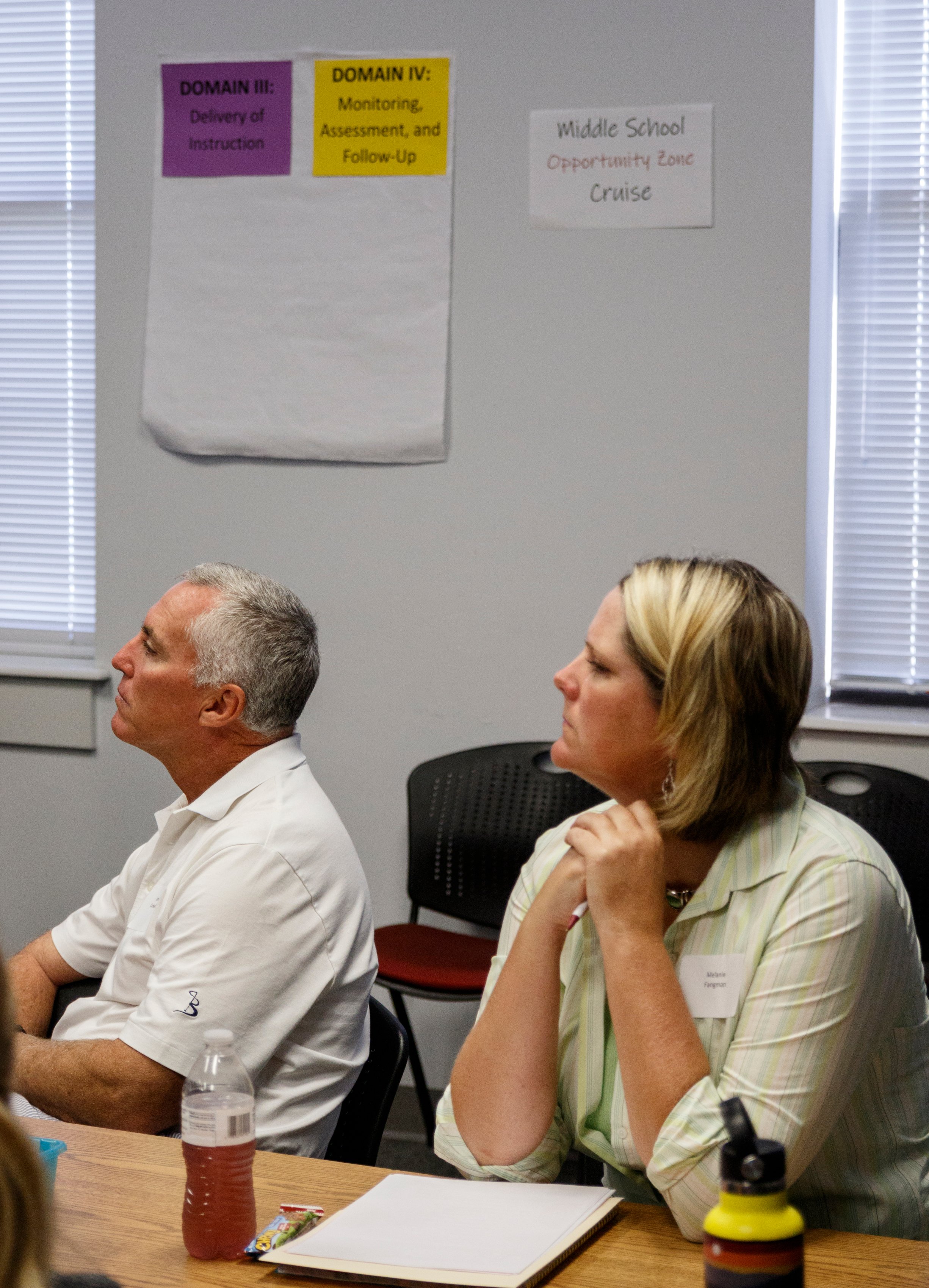 Melanie Fangman, right, and James Cardwell Jr. listen during a new hire orientation at Hamilton County Schools Central Office on Wednesday, July 10, 2019, in Chattanooga, Tenn. Teachers and central office hires learned about working for the department during the orientation.