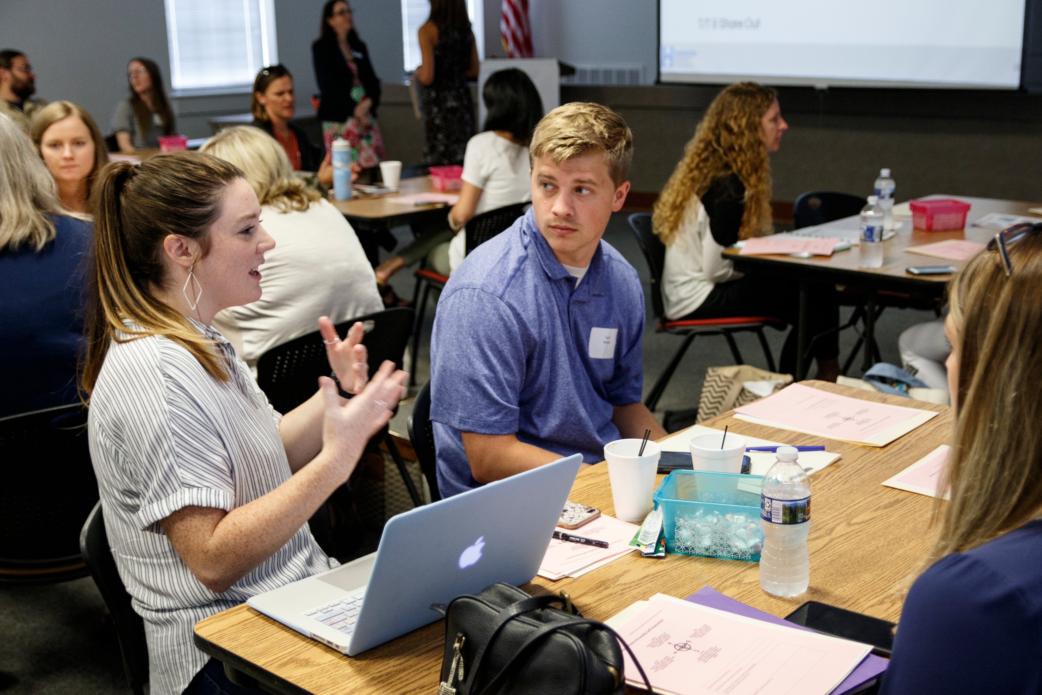 Tori Bell, left, and Taylor Bentley talk at their table during a new hire orientation at Hamilton County Schools Central Office on Wednesday, July 10, 2019, in Chattanooga, Tenn. Teachers and central office hires learned about working for the department during the orientation.