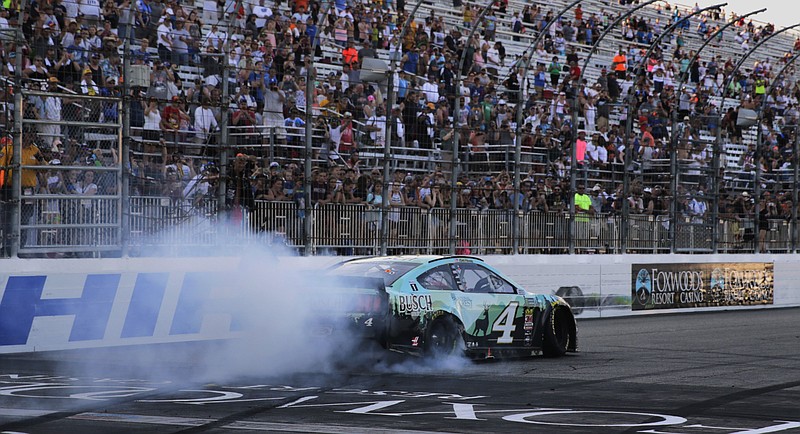 Kevin Harvick celebrates with a burnout after winning Sunday's NASCAR Cup Series race at New Hampshire Motor Speedway.