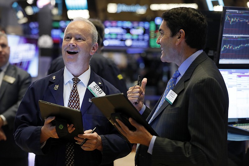 Traders James Riley, left, and Mark Muller work on the floor of the New York Stock Exchange, Monday, July 22, 2019. U.S. stocks moved higher in early trading Monday on Wall Street as investors snapped up technology stocks. (AP Photo/Richard Drew)