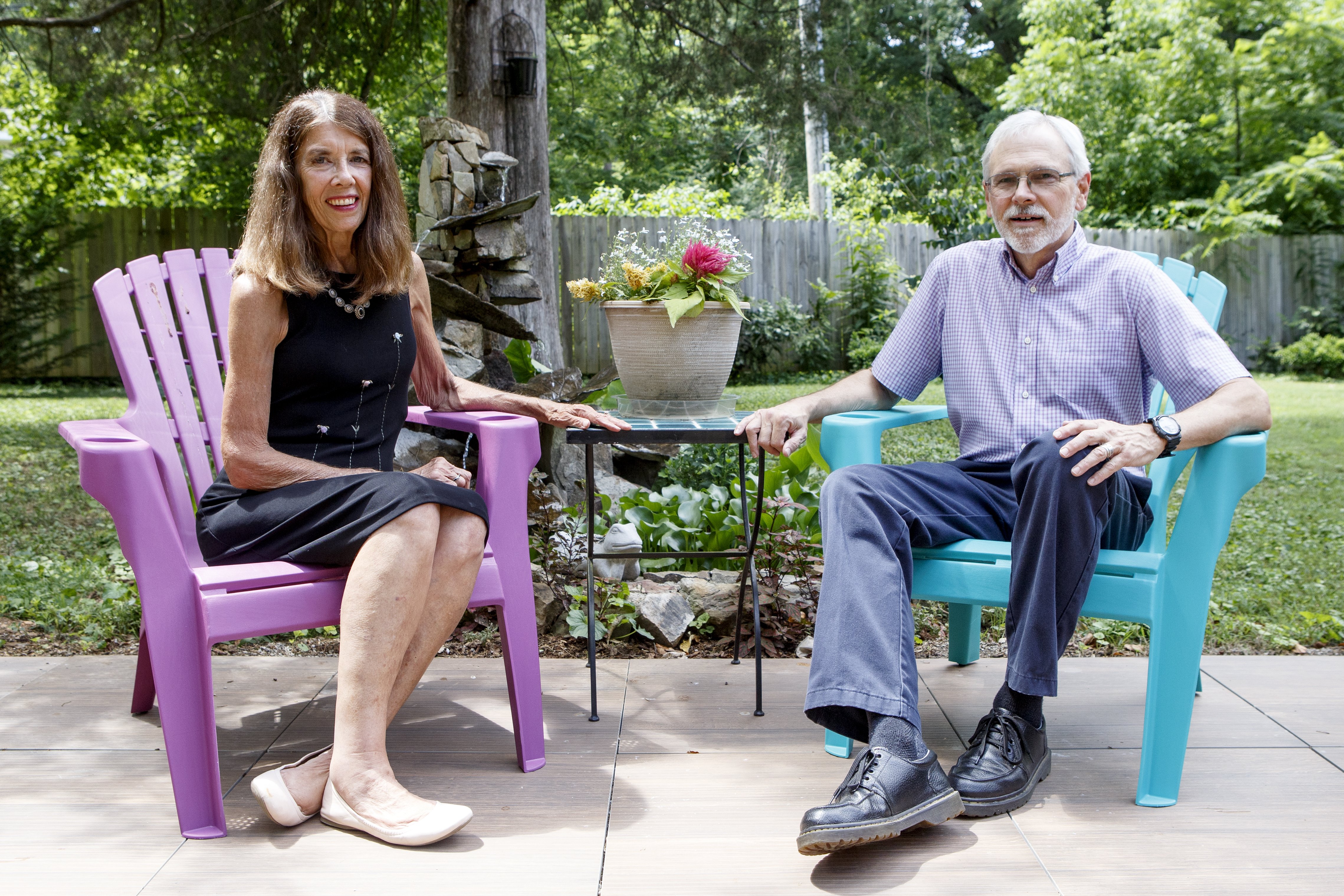 Owners Nancy and Wallace Braud relax in the backyard at St. Francis Cottage. The table between them was purchased at a discount at a resale store.