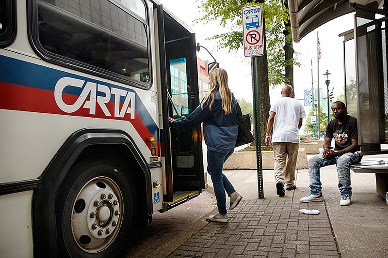 Times Free Press reporter Allison Collins pretends to board a CARTA bus on Market Street on Friday, July 12, 2019, in Chattanooga, Tenn. 