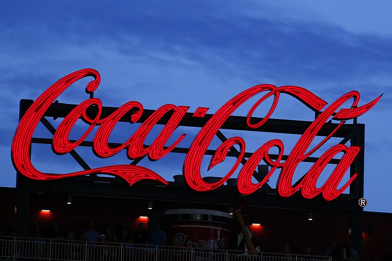 In this July 20, 2019, photo a Coca-Cola billboard is shown over left field at SunTrust Park during a baseball game between the Washington Nationals and Atlanta Braves in Atlanta. The Coca-Cola Co. reports earnings Tuesday, July 23. (AP Photo/John Bazemore)