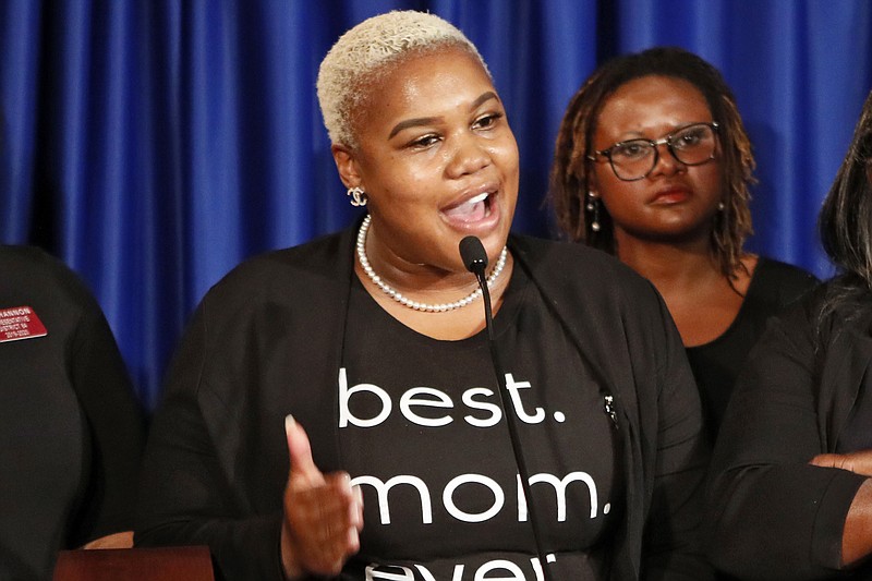 FILE - In this May 7, 2019 file photo Rep. Erica Thomas, D-Austell, speaks during a news conference in Atlanta. Thomas says she was verbally attacked in a supermarket by a white man who told her, "Go back where you came from." Rep. Erica Thomas of Austell tearfully described the confrontation in a Facebook video Friday, July 19, 2019. She acknowledged being in an express line with too many items but said she got in the line because she is nine months pregnant and cannot stand for long periods. (Bob Andres/Atlanta Journal-Constitution via AP)

