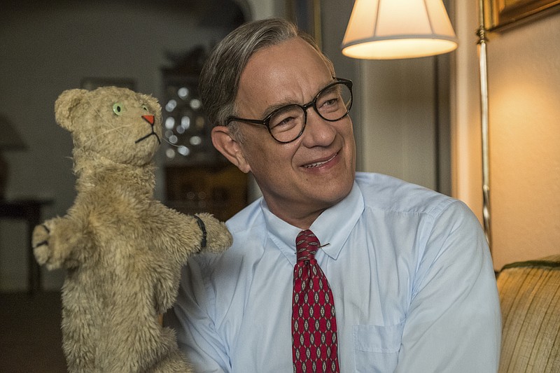 This image released by Sony Pictures shows Tom Hanks as Mister Rogers in a scene from "A Beautiful Day In the Neighborhood. The Mr. Rogers biopic will premiere at the Toronto International Film Festival in September. (Lacey Terrell/Sony-Tristar Pictures via AP)
