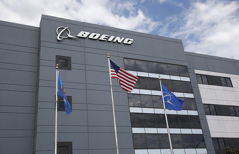 FILE - In this May 14, 2019, file photo flags fly outside the main building of The Boeing Company's Oklahoma City facility in Oklahoma City. Boeing Co. reports earning on Wednesday, July 24, 2019. (AP Photo/Sue Ogrocki, File)